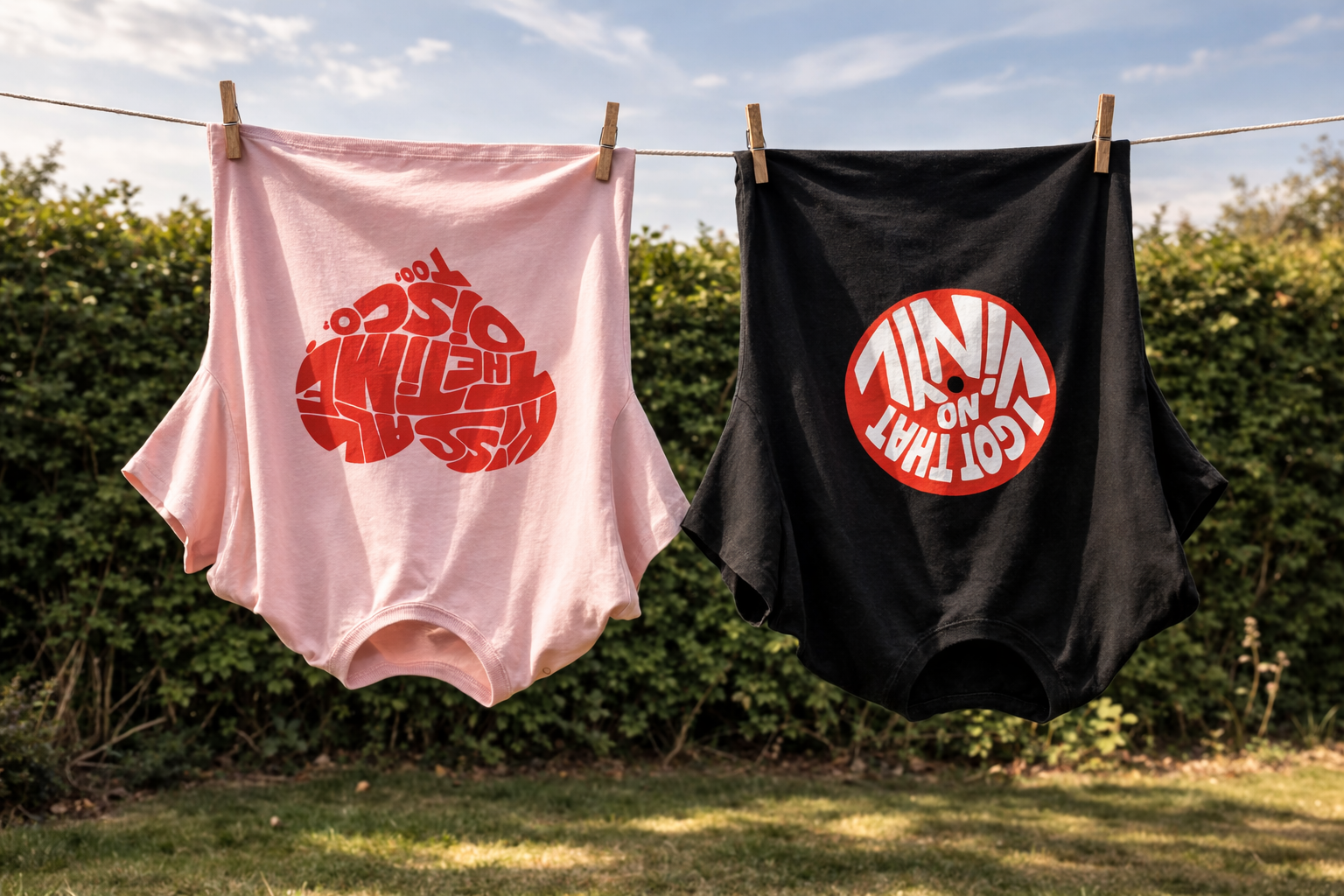 Two VERSEO t-shirts with red and white graphics hanging on a clothesline outdoors.